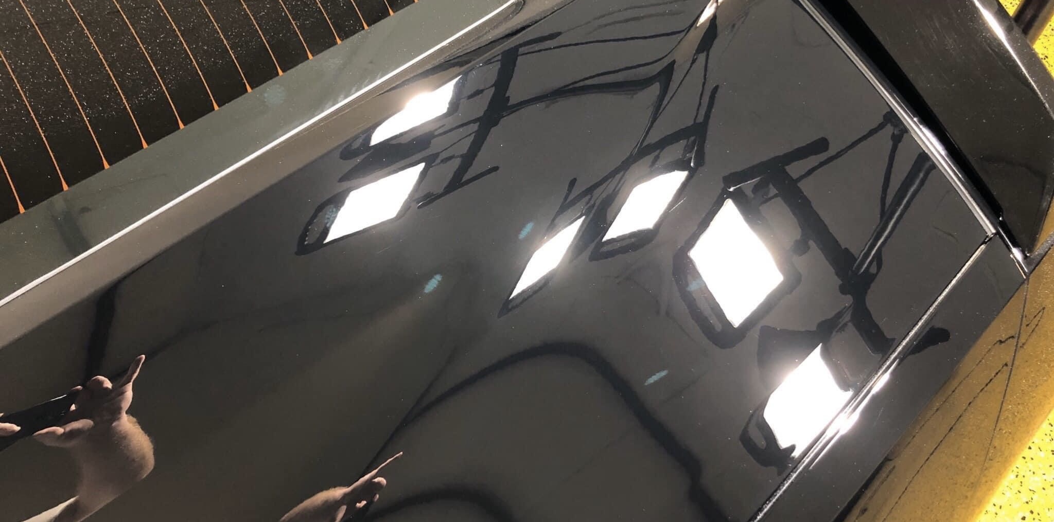 Black paint with swirls and scratches before correction